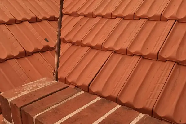 Restored tile roof with re-pointed chimney brickwork